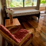 Scenic room with panoramic window view of Coorg's natural scenery at Rosewood Stay